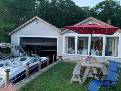 Stunning lakefront home with a boathouse, private dock, firepit and lake views