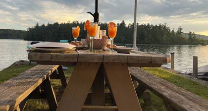 Stunning lakefront home with a boathouse, private dock, firepit and lake views