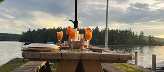 Stunning lakefront home with a boathouse, private dock, firepit and lake views