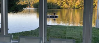 Stunning lakefront home with a boathouse, private dock, firepit and lake views