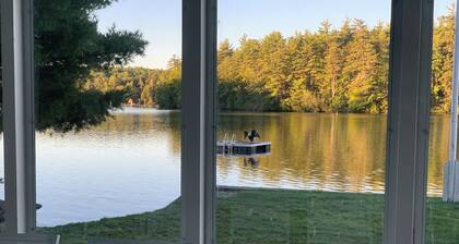 Stunning lakefront home with a boathouse, private dock, firepit and lake views