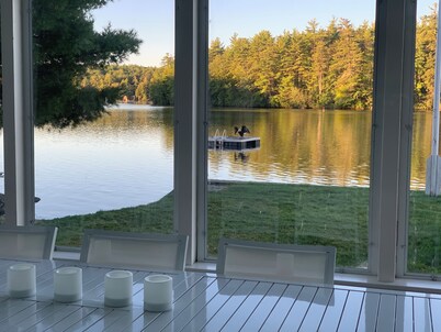 Stunning lakefront home with a boathouse, private dock, firepit and lake views