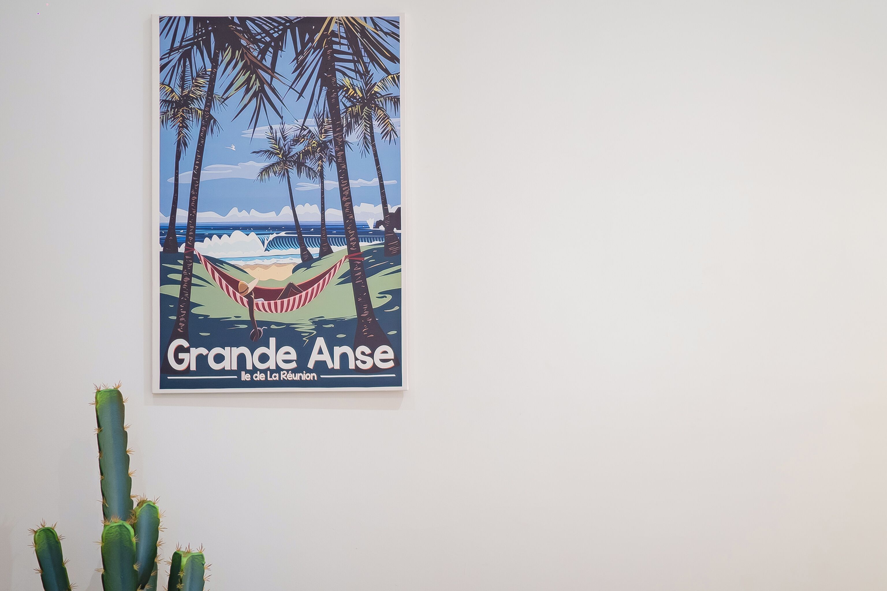 A poster of Grande Anse beach with palm trees and a hammock.