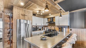 A modern kitchen with wooden accents, stainless steel appliances, and a central island. - Luxury Mountain Retreat.Minutes from ski slopes,Water Park,Resort & scenic hikes (Vernon Township)