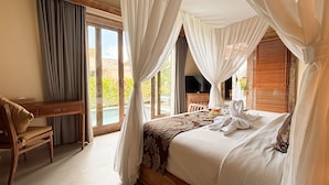 A hotel room with a bed, a desk, a TV, and a view of the outdoors. - Dlobong Private Pool Villa Ubud (Sukawati)