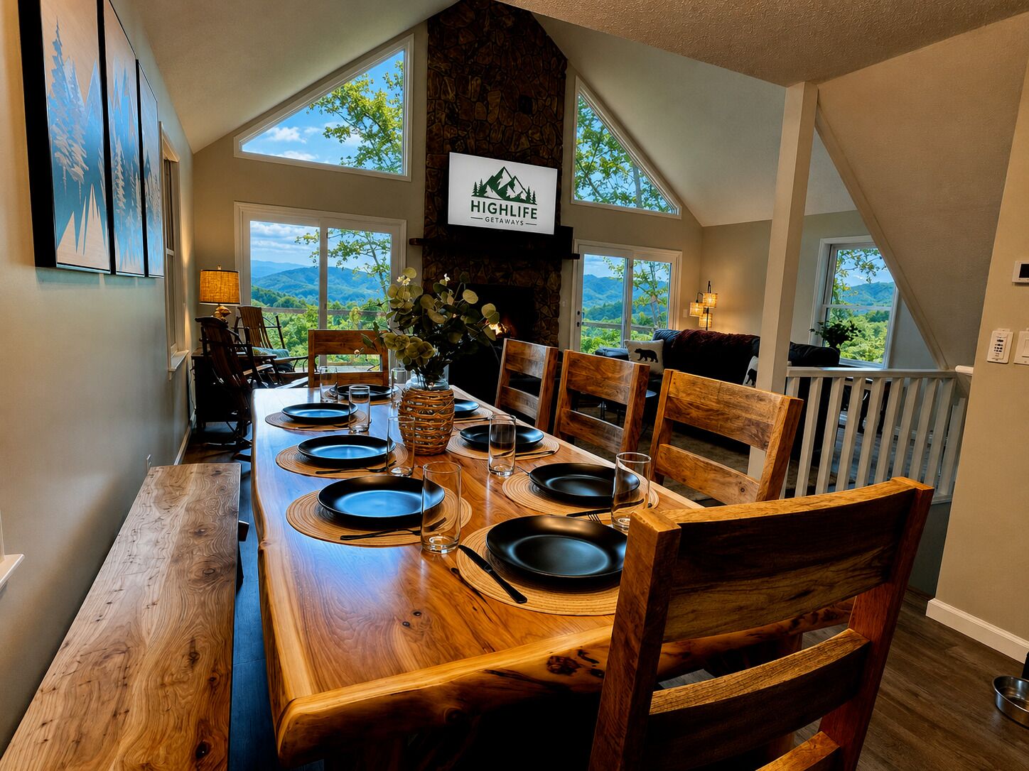 A dining area with a high ceiling, stone wall, and a view of the mountains.