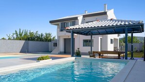 A modern house with a swimming pool, a covered patio, and a well-maintained garden. - Holiday Home Eros (Sibenik)