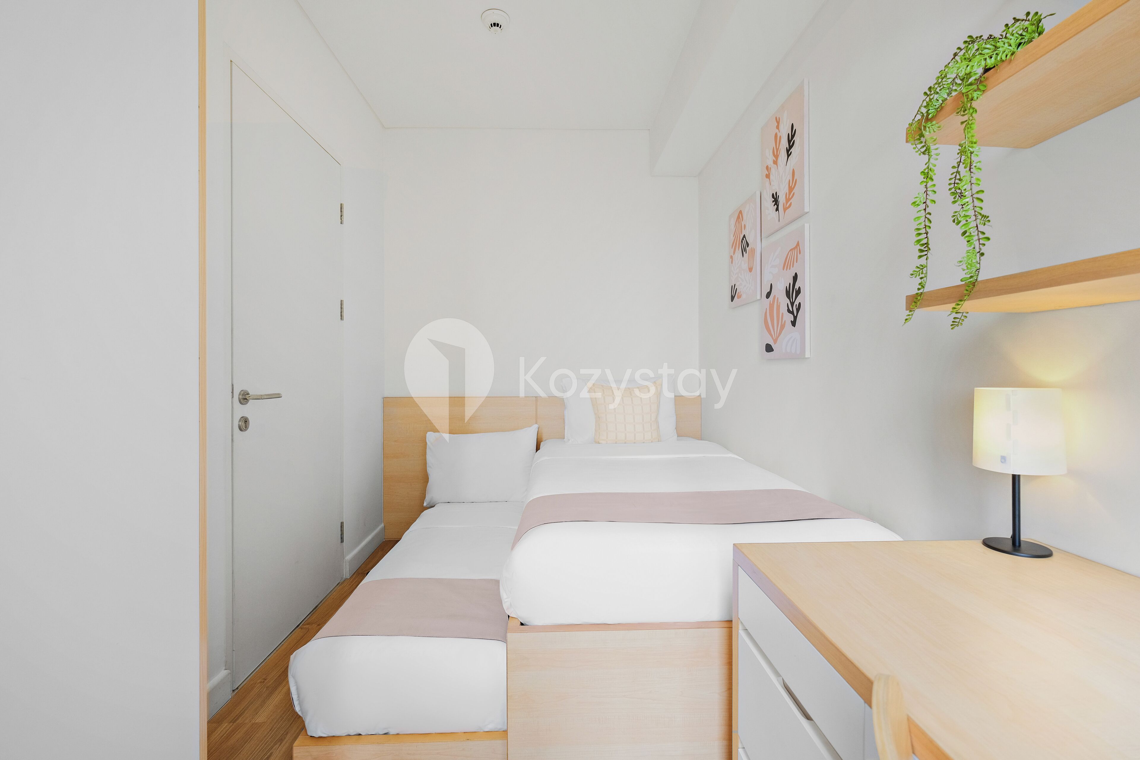 A modern, minimalist bedroom with a single bed, bedside tables, and a wall-mounted shelf with a plant.