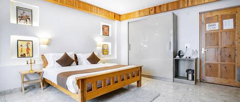 A bedroom with a wooden bed, a ceiling fan, and a wardrobe with a sliding door.