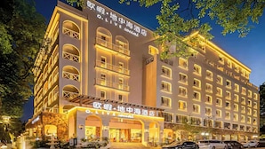 A multi-story hotel with a prominent 'O.LIVE social' sign, featuring balconies and a stone facade. - Guilin O-LIVE Social Hotel  (Guilin)