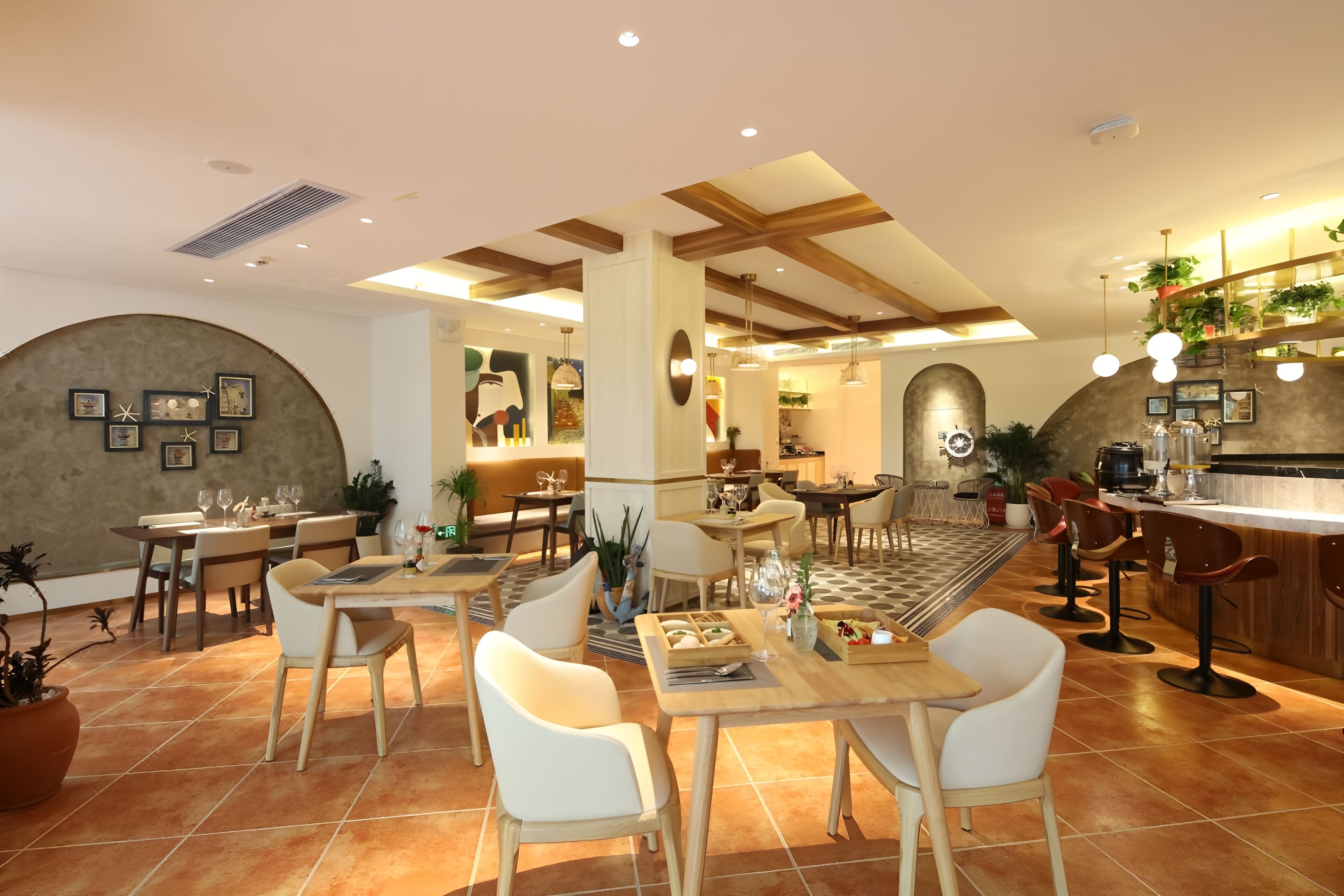 A modern restaurant interior with wooden tables and chairs, a kitchen area, and a bar.