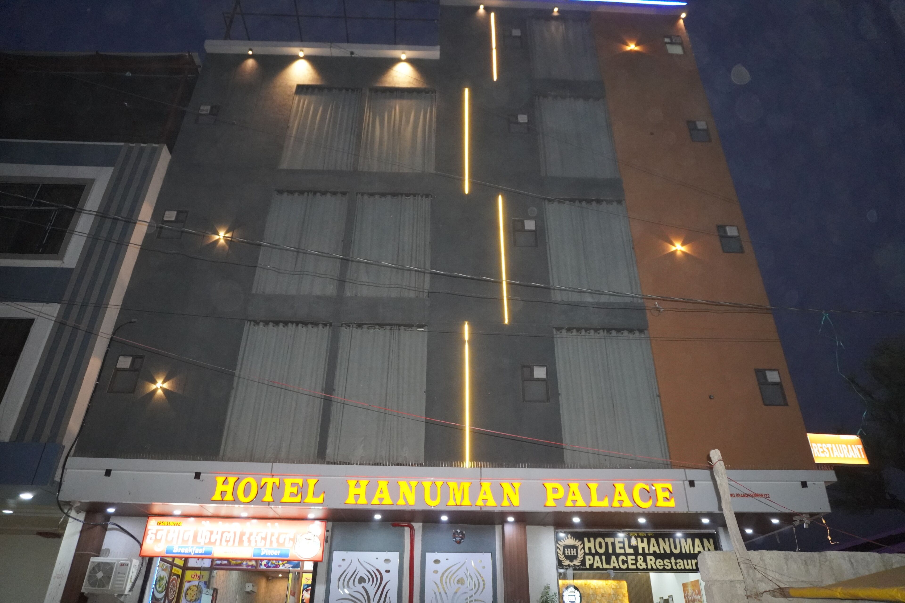 A hotel named 'Hotel Hanuman Palace' with a signboard and entrance.