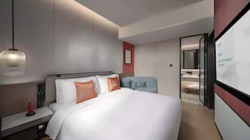 Deluxe Suite, Courtyard View | Desk, laptop workspace, blackout drapes, iron/ironing board