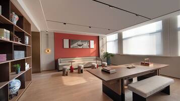 A modern living room with a sofa, coffee table, and bookshelves.