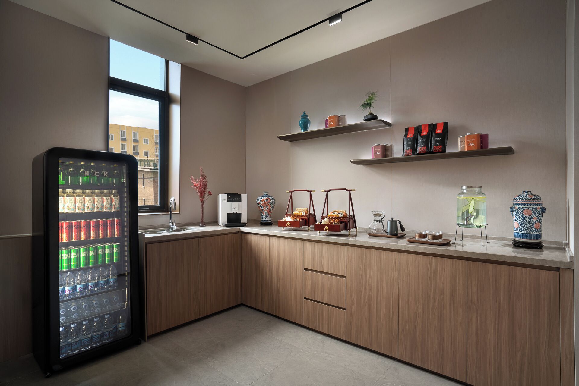 A modern kitchen with a built-in refrigerator, wooden cabinets, and a window providing a view of the outside.