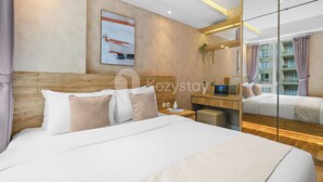 A modern hotel room with a large bed, a desk, and a mirror. - Laeta by Kozystay - Paskal (Bandung)
