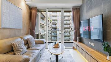 Apartment, 2 Bedrooms, City View | Living area | 55-inch Smart TV with cable channels, Netflix, streaming services