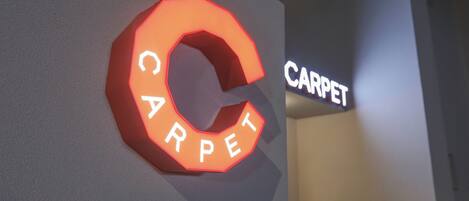 A sign with the word "CARPET" in capital letters, indicating a carpet-related business or service.