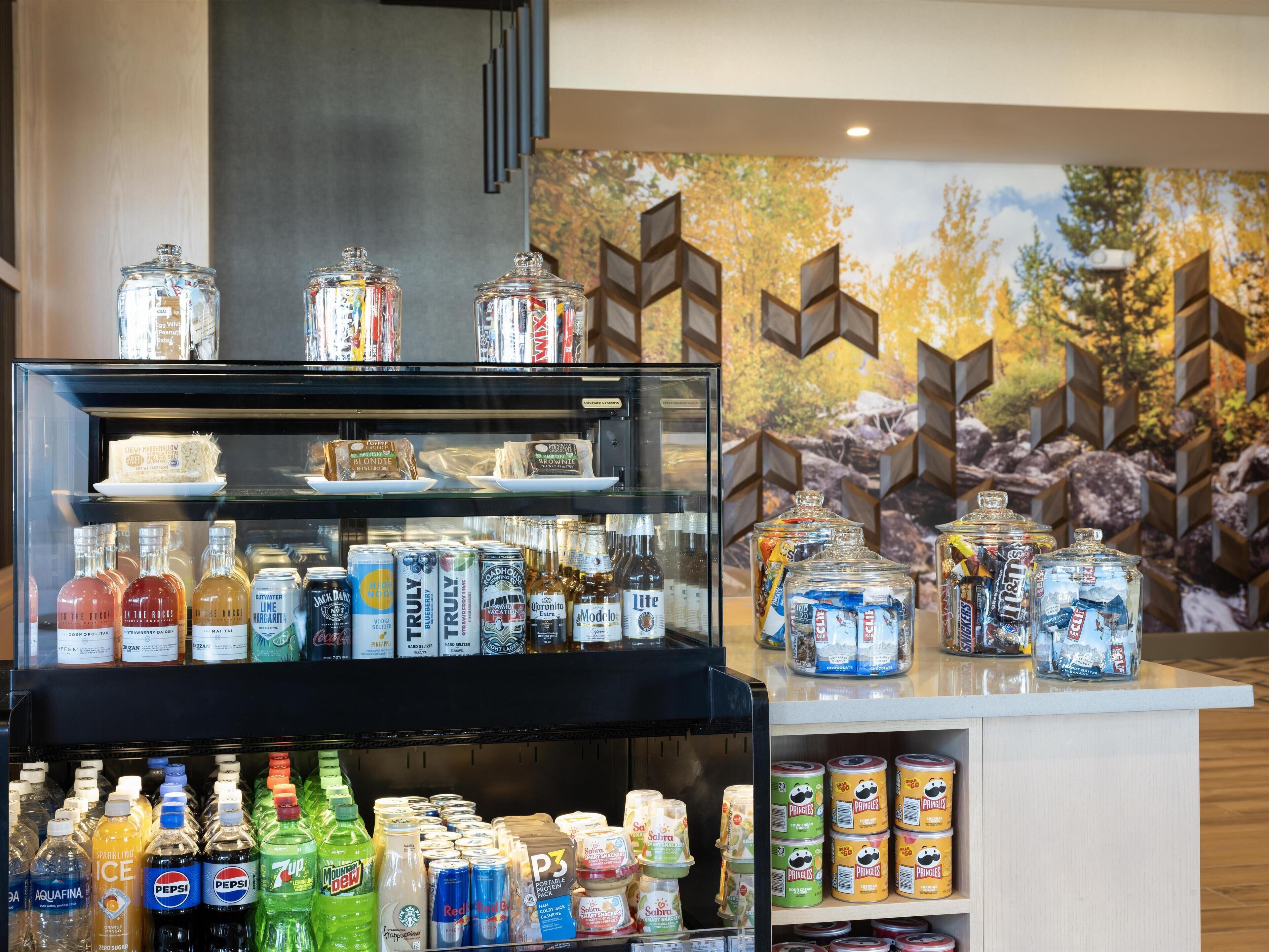 A beverage display with various drinks and snacks.