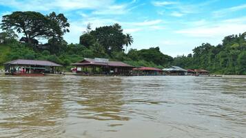A riverside restaurant with multiple buildings, including a prominent 'Family Restaurant' sign.