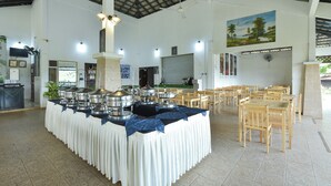 A spacious hall with a high ceiling, a reception area, and a buffet table with multiple serving stations. - Hotel O Asiacamp Resort National Park Kuala Tahan (Kuala Tahan)