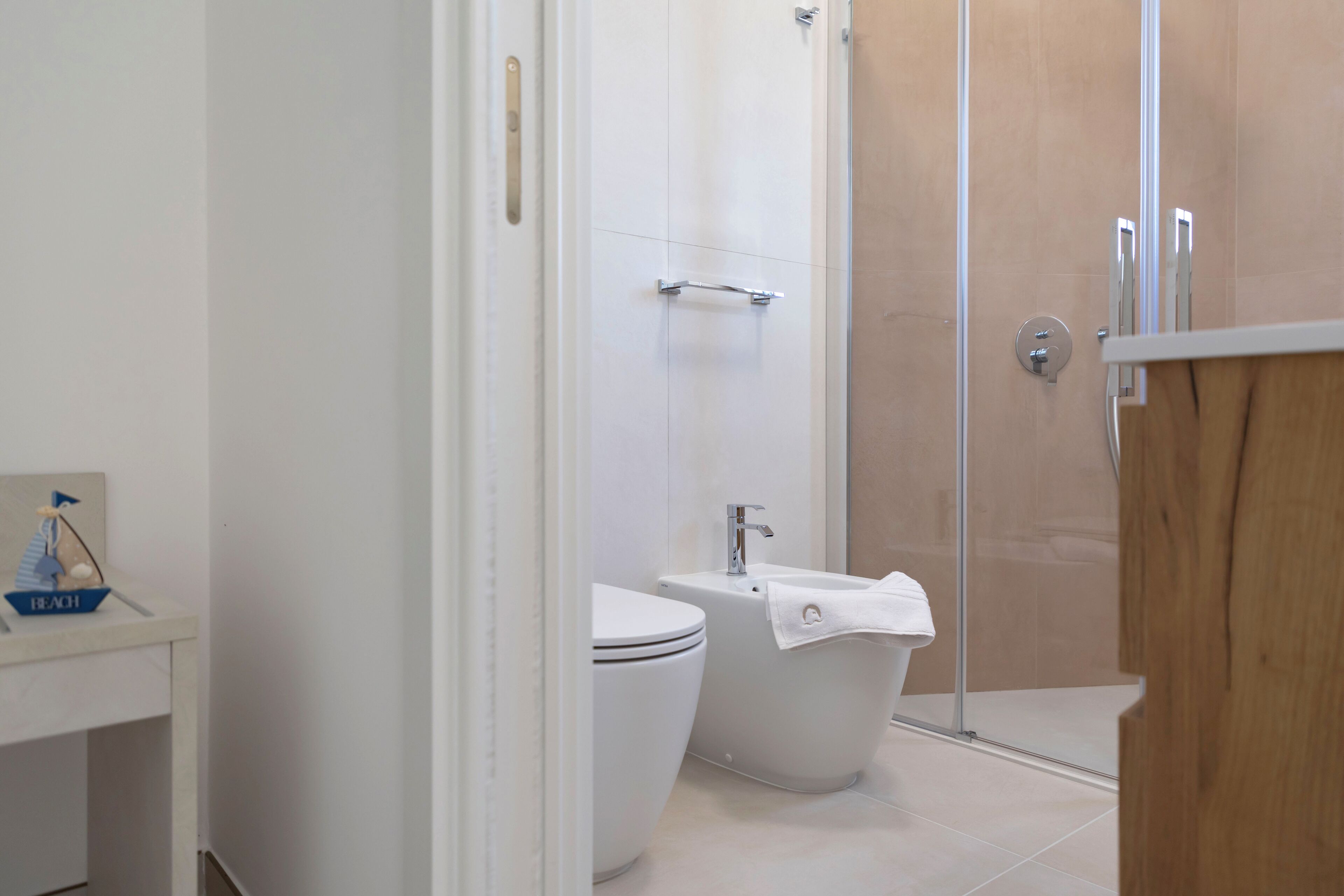 A bathroom with a toilet, a bathtub, and a shower enclosure.