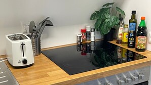 A kitchen with a toaster, a knife set, a plant, and various condiments on the counter. - Vacation apartment in Freudenstadt-Kniebis I, Black Forest (Freudenstadt)
