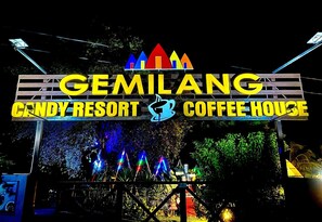 A sign for Gemilang Candy Resort and Coffee House with colorful lights and a logo. - Capital O 91167 Gemilang Candi Resort (Merbok)