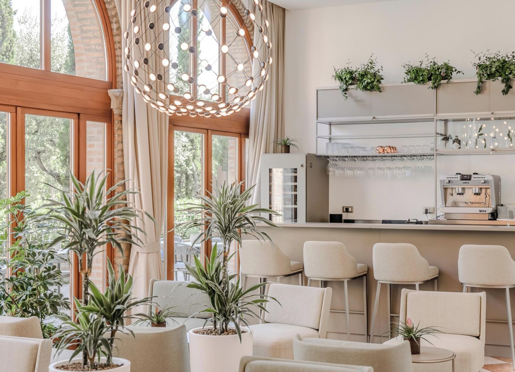 Un intérieur moderne avec un bar, des sièges et des plantes en pot.
