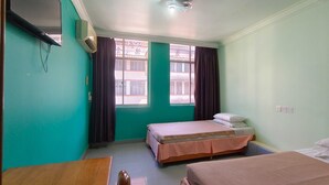 A room with two beds, a TV, and a window with curtains. - Hotel O Malaysia Hotel (Sandakan)