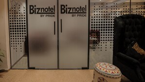 A BIZnotel with two doors labeled "Mr. Confectioner" and "By Pride". - Biznotel by Pride Surat (Surat)
