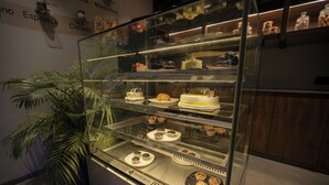 A bakery display case with various pastries and cakes. - Biznotel by Pride Surat (Surat)
