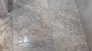 Un suelo de baldosas con un desagüe en la esquina.