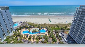 A resort with a beach view, multiple swimming pools, and a parking area. - Ocean Front, 1602 Royale Palms, full resort access!! (Myrtle Beach)
