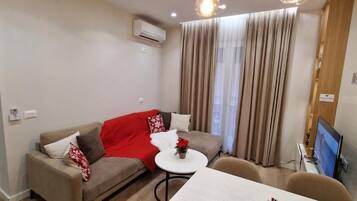 Apartment | Living area | 50-inch flat-screen TV with satellite channels