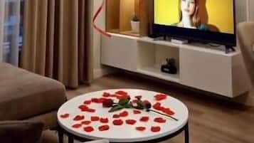 Apartment | Living area | 50-inch flat-screen TV with satellite channels