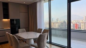 Three-Bedroom Deluxe Apartment | Private kitchen | Oven, stovetop