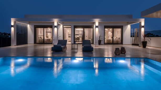 A modern house with a swimming pool, two lounge chairs, and a dining area. - Valley View 2 Bedroom Villa with Private Pool (Zakinthos)