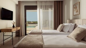 A hotel room with two beds, a desk, and a TV. - Valley View 2 Bedroom Villa with Private Pool (Zakinthos)