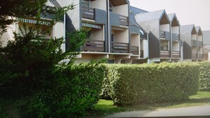 A row of modern, multi-story buildings with a unique architectural design featuring angular roofs and balconies.