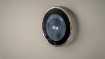 A circular device with a digital display and the word "ECO" on it.
