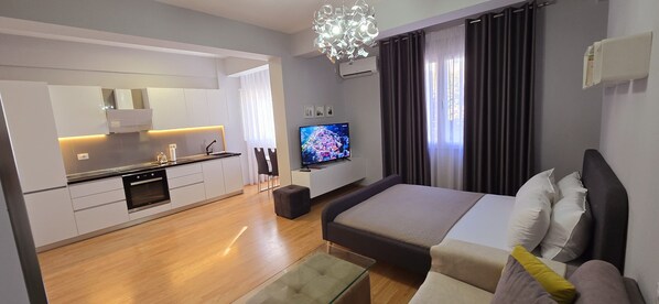 Deluxe Apartment | Living area | 40-inch Smart TV with cable channels
