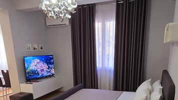 Deluxe Apartment | Living area | 40-inch Smart TV with cable channels