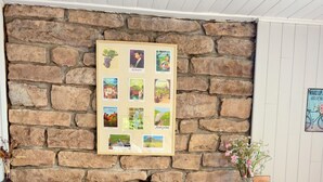 A brick fireplace with a framed poster above it. - Panoramic Chalet (Cenves)