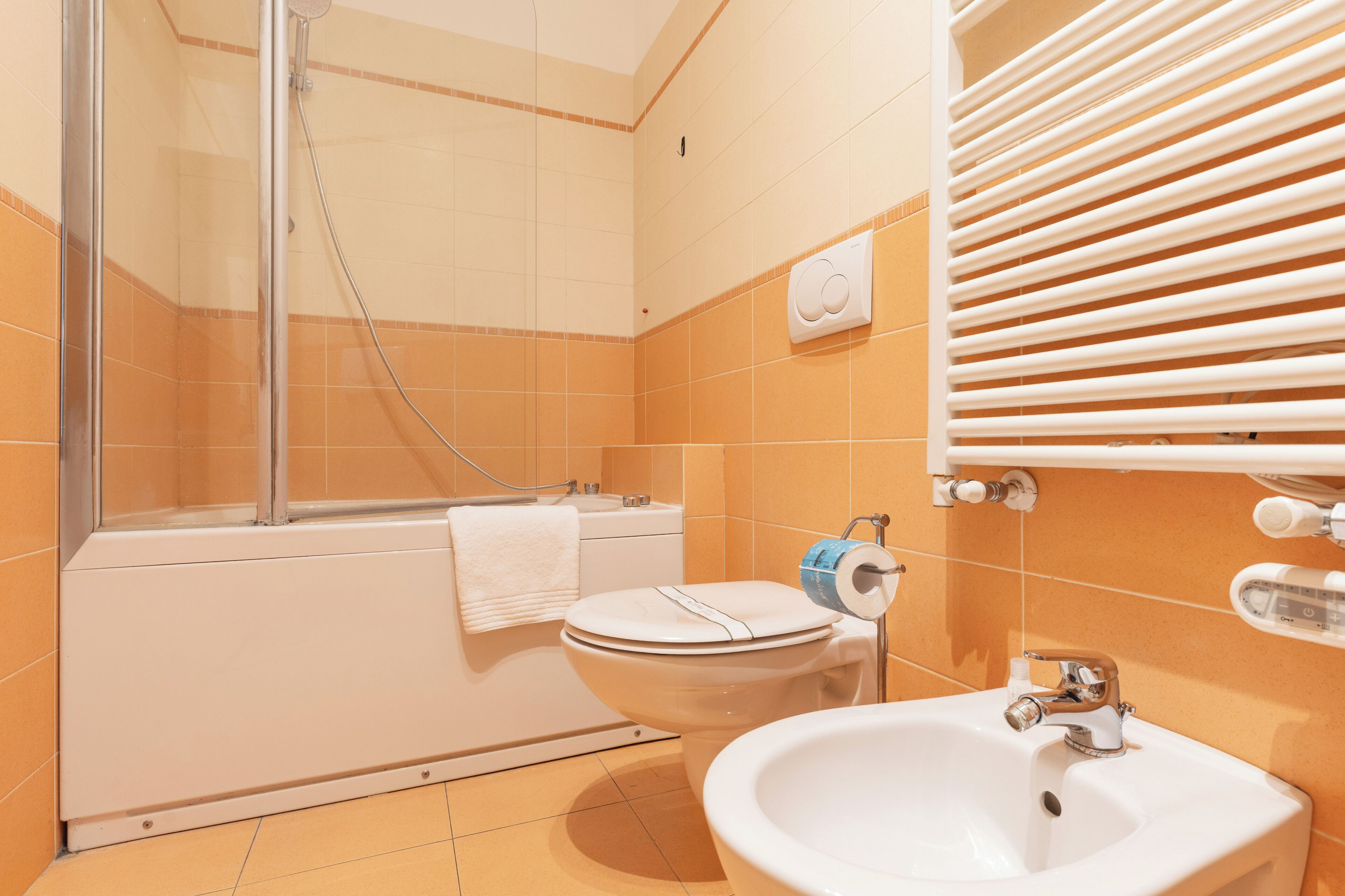 A bathroom with a bathtub, toilet, and sink.