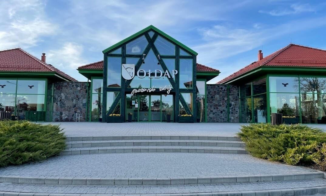 A building with a green roof and a sign that reads "OldAP".