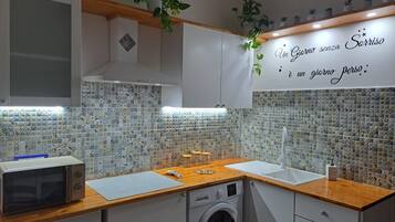 Fridge, microwave, coffee/tea maker, cookware/dishes/utensils
