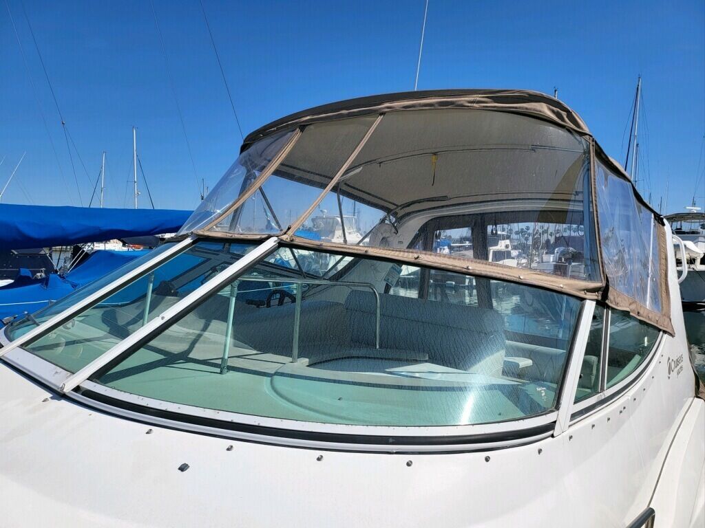 A boat with a covered cockpit and a steering wheel.