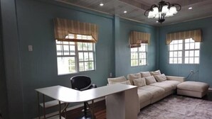 A room with teal walls, a white desk, a beige sofa, and a chandelier. - DougVille 43
 Tranquillity and Peace await! (Venezuela Scheme)