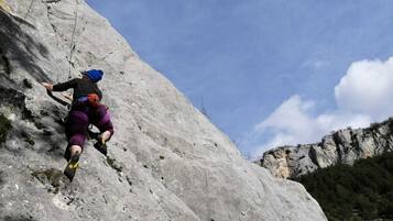 A person climbing a rocky mountain.